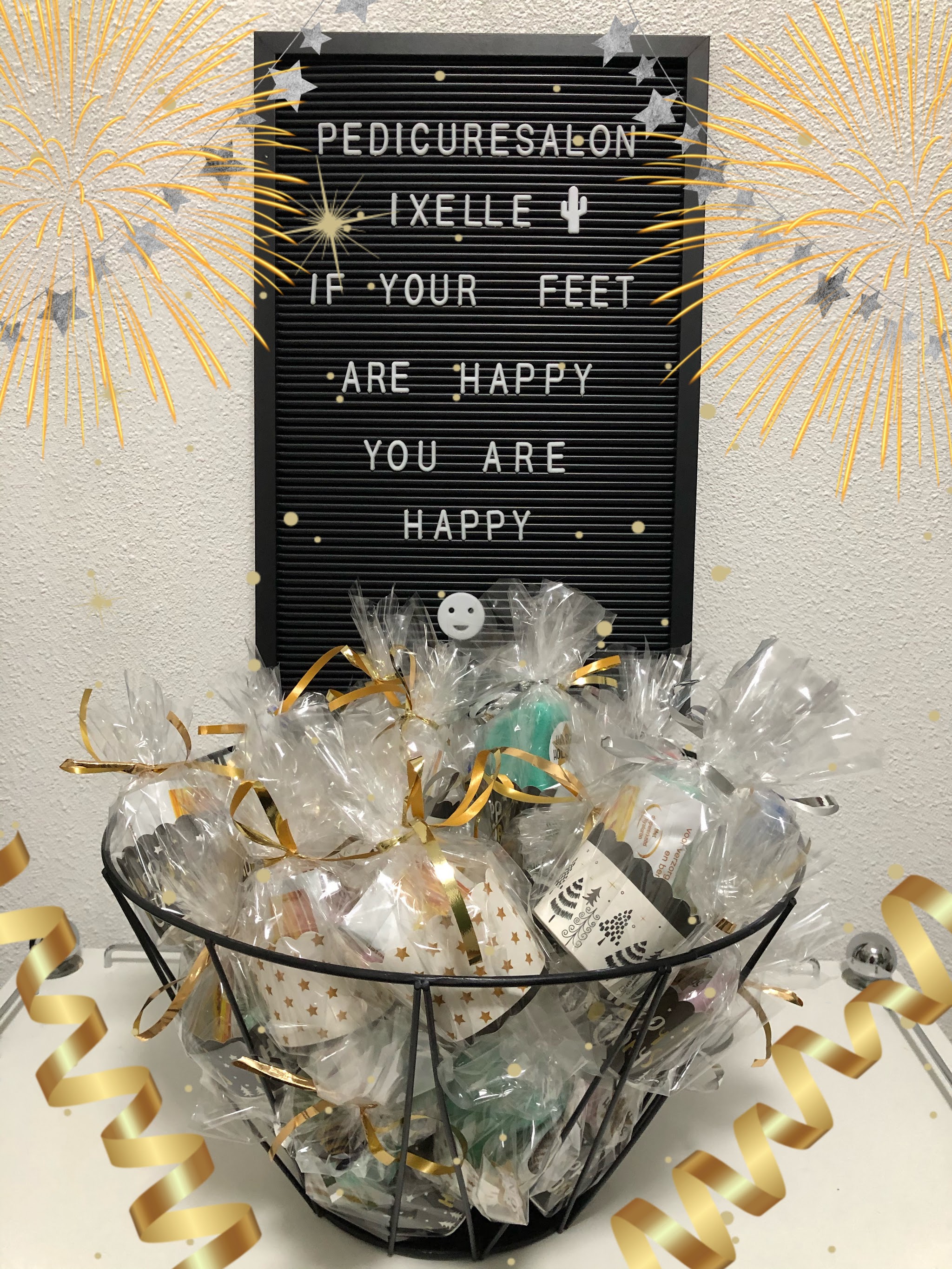 Het letterbord van Pedicuresalon Ixelle met de tekst If your feet are happy you are happy, met een mand cadeauzakjes